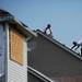 Crews work on a tornado-damaged home in the Huron Farms subdivision in Dexter on Monday. Melanie Maxwell I AnnArbor.com
